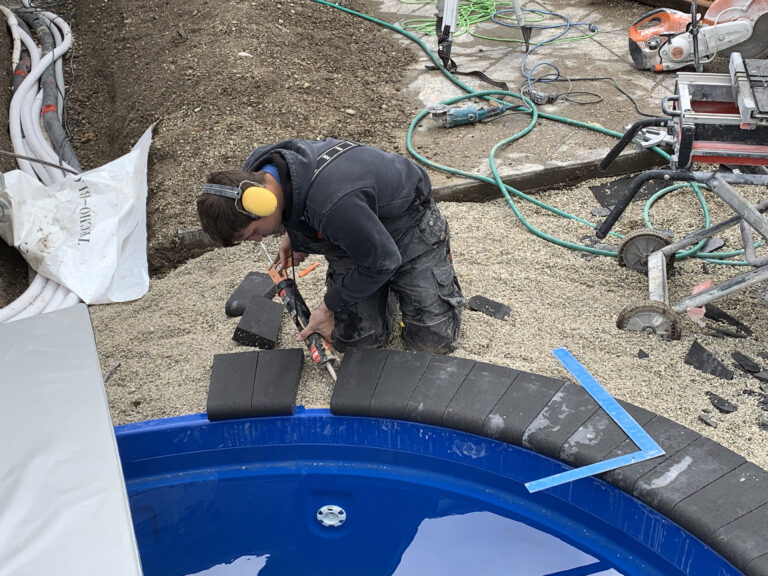 Landscaping project featuring custom hardscapes and a beautiful pool installation in Alliston