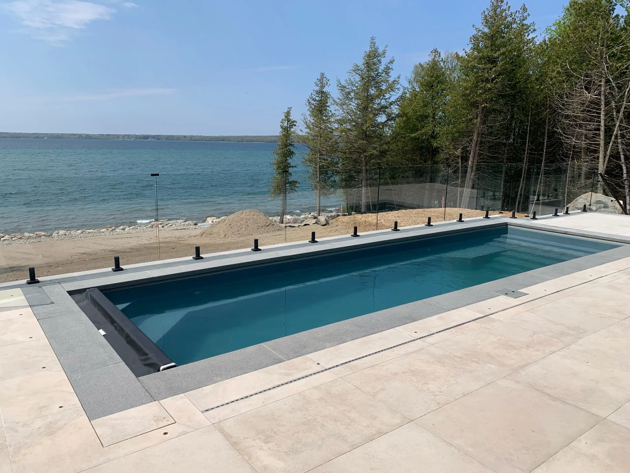 A fiberglass swimming pool installation with a beautiful landscape view in Barrie, ON