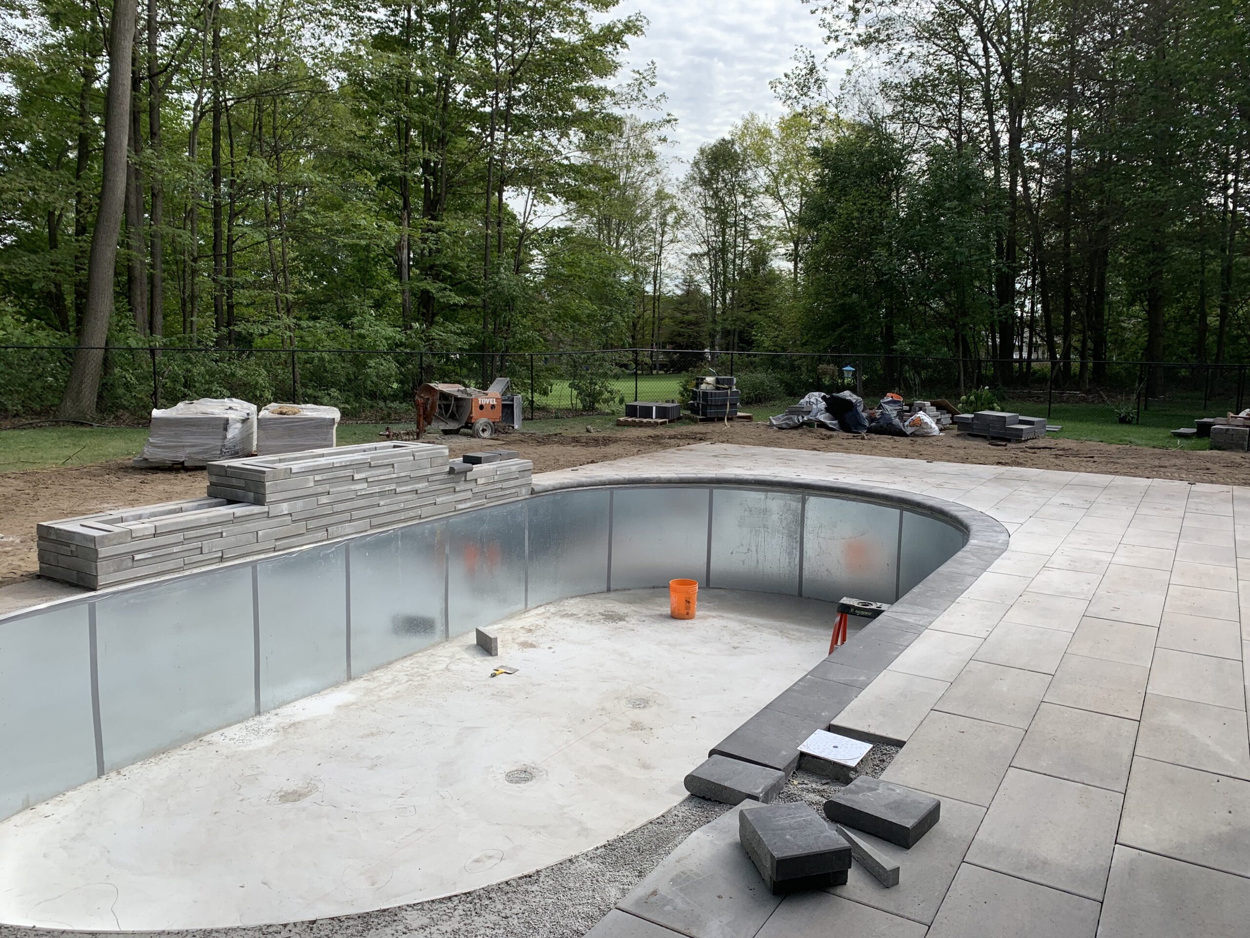 An elaborate water feature and swimming pool installation in Barrie, ON by MBM Conscapes