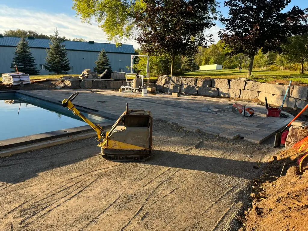 Compacting around a fiberglass pool installation