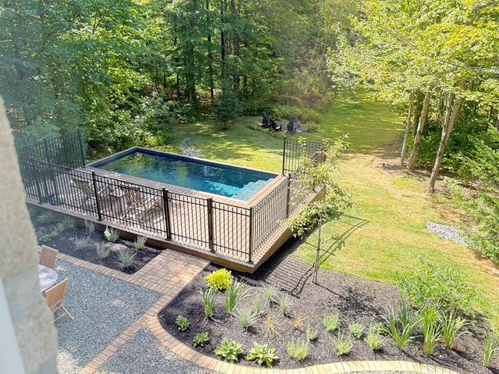 A beautiful perspective photo of an inground concrete pool